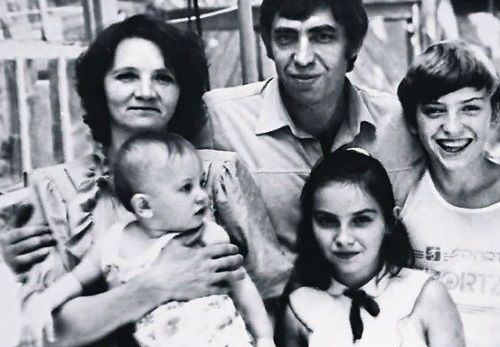 Павлик в детстве с семьей у мамы на коленях